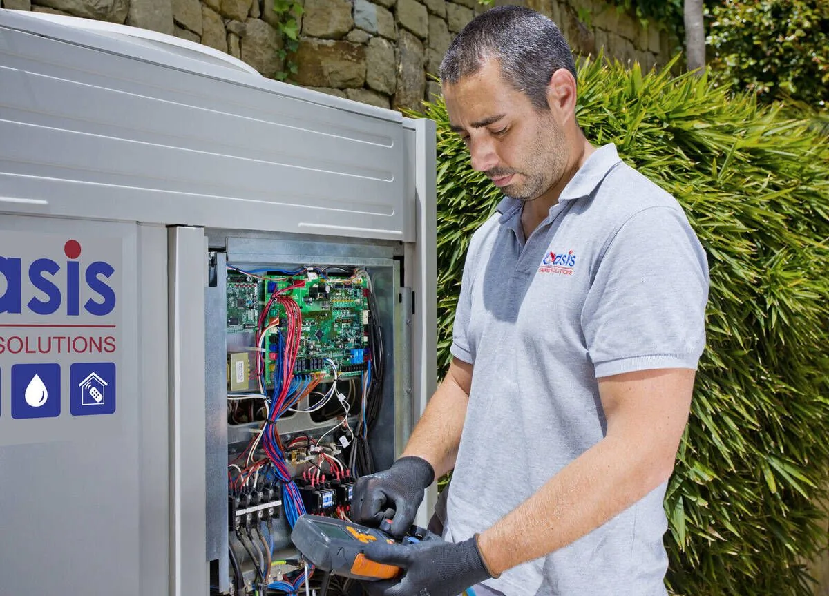 Oasis engineer servicing air conditioning unit